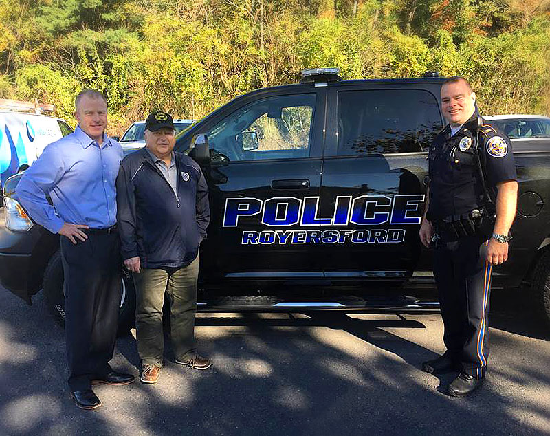 Richard Lewis (left), President of The Lewis Group, presents the newly upgraded police vehicle outfitted with specialized equipment to Royersford, Pennsylvania Mayor John Guest and Chief of Police, Tom Berlinger (right). 